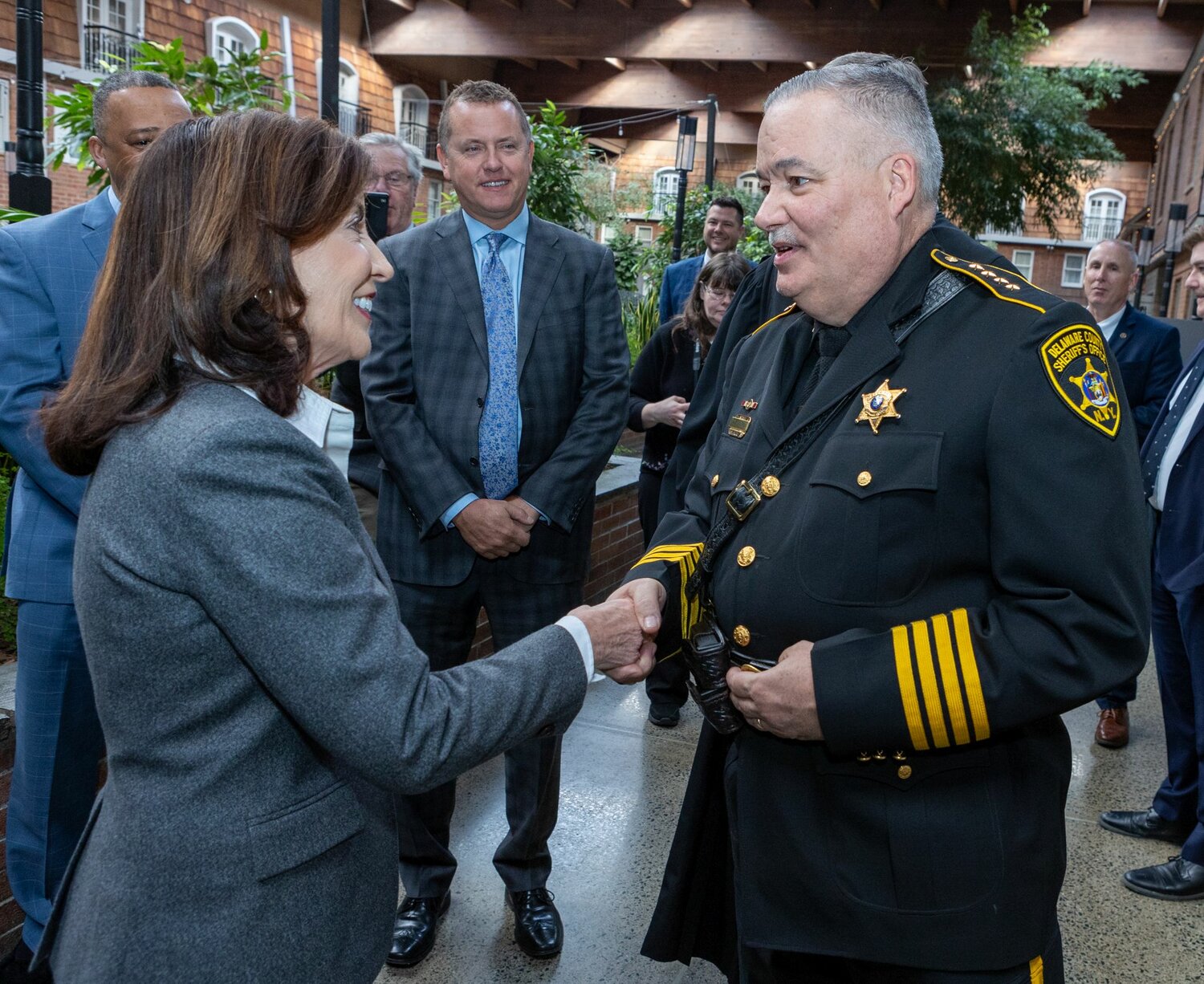 Sheriff Craig DuMond greets Governor Kathy Hochul prior to the swearing-in ceremony in Albany.